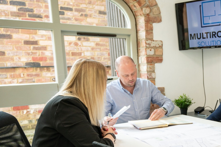 Team reviewing lease documents around a meeting table